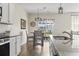 Well-lit kitchen with stainless steel appliances, granite countertops, and an adjacent dining area with wood floors at 7037 Grant St., Little River, SC 29566