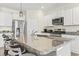 Kitchen featuring an island with granite countertops and stainless steel appliances, complemented by white cabinetry at 7037 Grant St., Little River, SC 29566