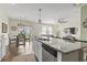 Open-concept kitchen with granite island, stainless steel appliances, and a view of the breakfast nook and living area at 7037 Grant St., Little River, SC 29566