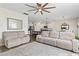 Open-concept living area with comfortable seating, large rug, ceiling fan, and view into the adjacent kitchen space at 7037 Grant St., Little River, SC 29566