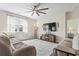 Spacious living room featuring plush sofas, a large ceiling fan, a decorative rug, and a wall-mounted television at 7037 Grant St., Little River, SC 29566