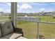 Screened-in porch showcasing picturesque pond views with a fountain feature at 7037 Grant St., Little River, SC 29566