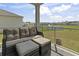 Screened-in porch featuring comfortable wicker furniture with a serene pond view at 7037 Grant St., Little River, SC 29566
