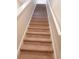 Carpeted staircase with white railing leading to the upper level of the home, providing safe and comfortable access at 7037 Grant St., Little River, SC 29566