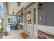 Charming front porch with blue Adirondack chairs, a decorative wreath, and a 