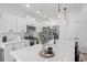Modern kitchen with white cabinets, stainless steel appliances, a large marble island, and pendant lighting fixtures at 804 Edisto Ct., Myrtle Beach, SC 29588