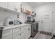 Functional laundry room with modern washer/dryer, ample counter space, and storage cabinets at 804 Edisto Ct., Myrtle Beach, SC 29588