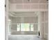 A spacious living room features a fireplace, large windows, and a tray ceiling under construction at 804 Edisto Ct., Myrtle Beach, SC 29588