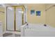 Bathroom with large white tub, gold fixtures, and glass shower at 901 Bear Lake Dr., Longs, SC 29568