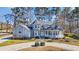 Beautiful home featuring manicured landscaping, stone driveway accents, and mature trees at 901 Bear Lake Dr., Longs, SC 29568