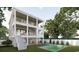 Beautiful backyard with a pristine pool, ample green space, and multiple balconies on a modern three-story home at 914 Perrin Dr., North Myrtle Beach, SC 29582