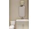 Bathroom with a toilet, single sink vanity with storage, mirror, and stylish pendant lighting fixture at 914 Perrin Dr., North Myrtle Beach, SC 29582