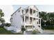 Elegant three-story home featuring a double porch, white railing, and convenient drive-under garage at 914 Perrin Dr., North Myrtle Beach, SC 29582