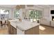 Bright kitchen features marble counters, apron sink, gold faucet, and seamlessly blends the indoor/outdoor spaces at 914 Perrin Dr., North Myrtle Beach, SC 29582