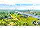 An aerial view captures a waterway, golf course, and residential area nestled amid lush greenery at 1545 Spinnaker Dr. # 2C, North Myrtle Beach, SC 29582