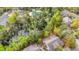 Aerial view of homes, community pool and a pond surrounded by lush trees at 1545 Spinnaker Dr. # 2C, North Myrtle Beach, SC 29582