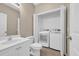 Functional bathroom area featuring vanity, toilet, and closet with washer and dryer at 1545 Spinnaker Dr. # 2C, North Myrtle Beach, SC 29582