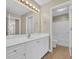 Spacious bathroom featuring a white vanity, mirror, and walk-in shower and view to bedroom at 1545 Spinnaker Dr. # 2C, North Myrtle Beach, SC 29582