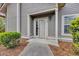 Charming front entrance with muted siding, a well-lit porch, and lush landscaping at 1545 Spinnaker Dr. # 2C, North Myrtle Beach, SC 29582