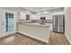 Stylish kitchen featuring white cabinetry, stainless steel appliances, and a breakfast bar at 1545 Spinnaker Dr. # 2C, North Myrtle Beach, SC 29582
