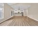 Spacious living room with hardwood floors, a modern chandelier, and plenty of natural light at 1545 Spinnaker Dr. # 2C, North Myrtle Beach, SC 29582