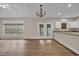 Inviting living room featuring hardwood floors, a large window, and French doors to the outdoor space at 1545 Spinnaker Dr. # 2C, North Myrtle Beach, SC 29582