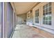 Relaxing screened-in patio featuring bike, string lights, and exterior doors at 1545 Spinnaker Dr. # 2C, North Myrtle Beach, SC 29582