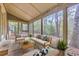 Inviting screened-in porch with comfortable seating and view of wooded area at 1545 Spinnaker Dr. # 2C, North Myrtle Beach, SC 29582