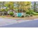 Community sign for Tidewater Ridge Clubhouse Villas, surrounded by lush greenery at 1545 Spinnaker Dr. # 2C, North Myrtle Beach, SC 29582