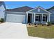 Charming single-story home showcasing a well-manicured lawn, two-car garage, and covered front entry at 1800 Sunshine Ct., North Myrtle Beach, SC 29582