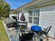 Backyard patio featuring a hot tub, table, and grill at 232 Marbella Dr., Murrells Inlet, SC 29576
