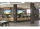Stylish bar area with TVs, stools, and a fully stocked bar in a modern design at 232 Marbella Dr., Murrells Inlet, SC 29576