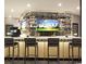 Upscale bar area with fully stocked shelves and multiple televisions for viewing golf at 232 Marbella Dr., Murrells Inlet, SC 29576