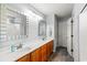 Bright bathroom featuring double sinks, a large mirror, and a shower/tub combo at 232 Marbella Dr., Murrells Inlet, SC 29576