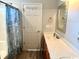 Clean bathroom featuring a vanity with storage and shower-tub combo behind a decorative shower curtain at 232 Marbella Dr., Murrells Inlet, SC 29576