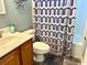 Neat bathroom featuring a vanity with storage and shower-tub combo behind a modern shower curtain at 232 Marbella Dr., Murrells Inlet, SC 29576