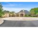 Elegant clubhouse featuring brickwork, arched entrances, and a roundabout with multiple flags at 232 Marbella Dr., Murrells Inlet, SC 29576