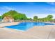 A large community pool with clear blue water and plenty of seating surrounded by lush trees at 232 Marbella Dr., Murrells Inlet, SC 29576