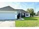 Well maintained single-story home with an attached two-car garage and pristine lawn at 232 Marbella Dr., Murrells Inlet, SC 29576