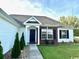 Inviting front entrance with manicured landscaping and brick accents around the window at 232 Marbella Dr., Murrells Inlet, SC 29576