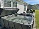 Backyard patio featuring a hot tub, table, and grill at 232 Marbella Dr., Murrells Inlet, SC 29576