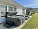 Backyard patio featuring a hot tub, table, and lounge chairs at 232 Marbella Dr., Murrells Inlet, SC 29576