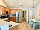 Well-lit kitchen featuring stainless steel appliances and wood cabinets and an adjacent dining area at 232 Marbella Dr., Murrells Inlet, SC 29576