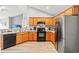 Well-lit kitchen with wood cabinets, stainless steel refrigerator, and modern appliances at 232 Marbella Dr., Murrells Inlet, SC 29576