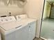 Laundry room with a washing machine and dryer, next to access to the garage at 232 Marbella Dr., Murrells Inlet, SC 29576