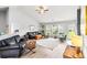 Spacious living room with vaulted ceilings, large windows, and stylish leather furniture at 232 Marbella Dr., Murrells Inlet, SC 29576