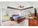 Spacious main bedroom with tray ceilings, large windows, and a ceiling fan at 232 Marbella Dr., Murrells Inlet, SC 29576