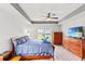 Comfortable main bedroom with ample natural light and stylish wood furniture at 232 Marbella Dr., Murrells Inlet, SC 29576