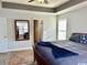 Spacious main bedroom features a tray ceiling, large windows, and ample natural light at 232 Marbella Dr., Murrells Inlet, SC 29576