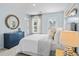 Bedroom featuring a dresser, round mirror and a glass door to balcony at 3313 Mid Summer Ln., North Myrtle Beach, SC 29582